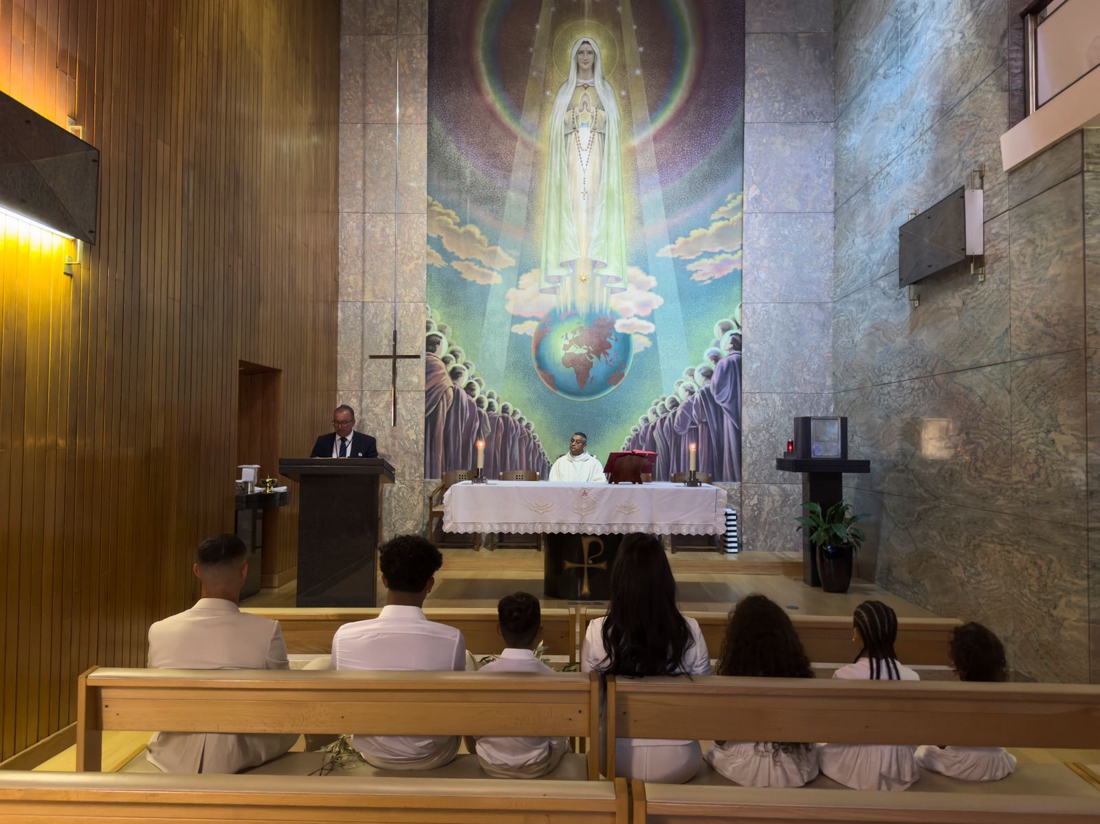Image may contain Alain Ramadier Altar Architecture Building Church Prayer Adult Person Child Plant and Wedding
